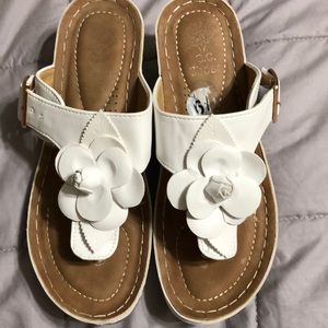 White flower sandals with 1” heel.